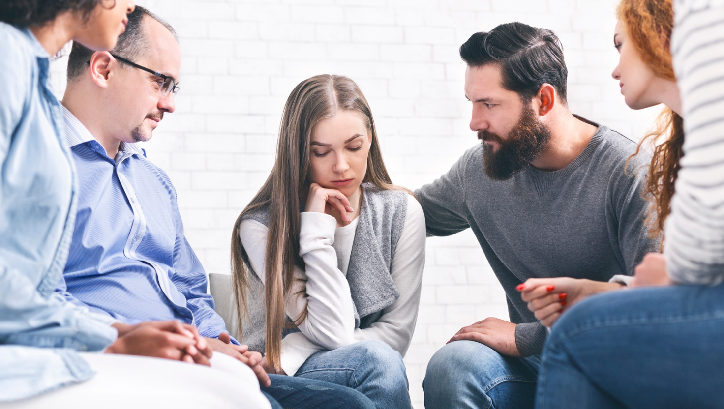 diverse group in therapy session discussing depression treatment options