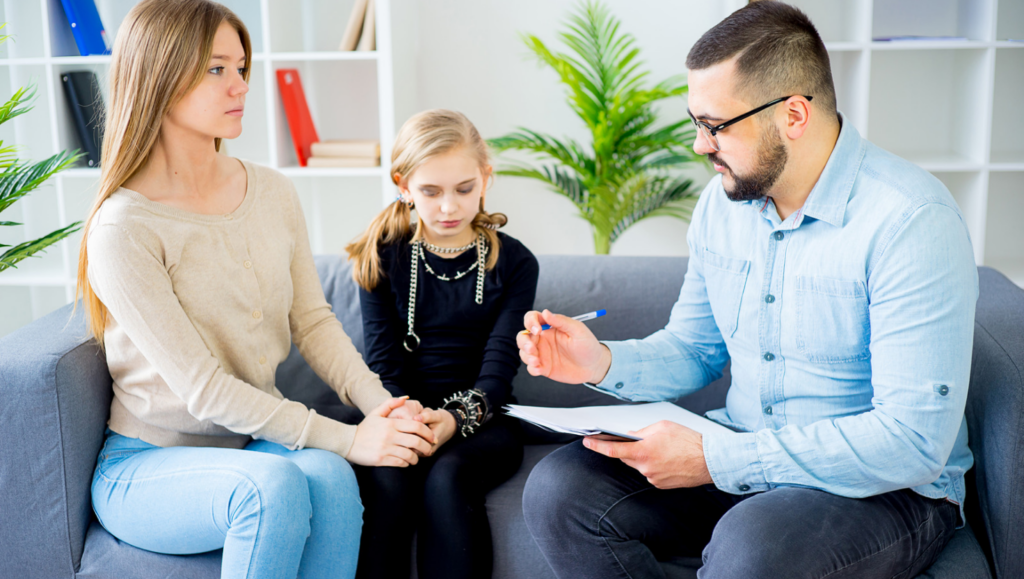 Supportive mental health professionals and parents collaborating on oppositional defiant disorder treatment strategies